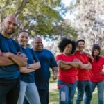 Diverse group of adults bonding and enjoying team activity in a park.